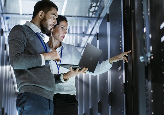 Man and woman inspect server racks and discuss vpn alternatives